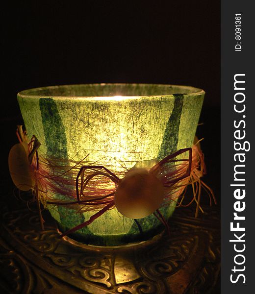 Glass candlestick with homemade decoration