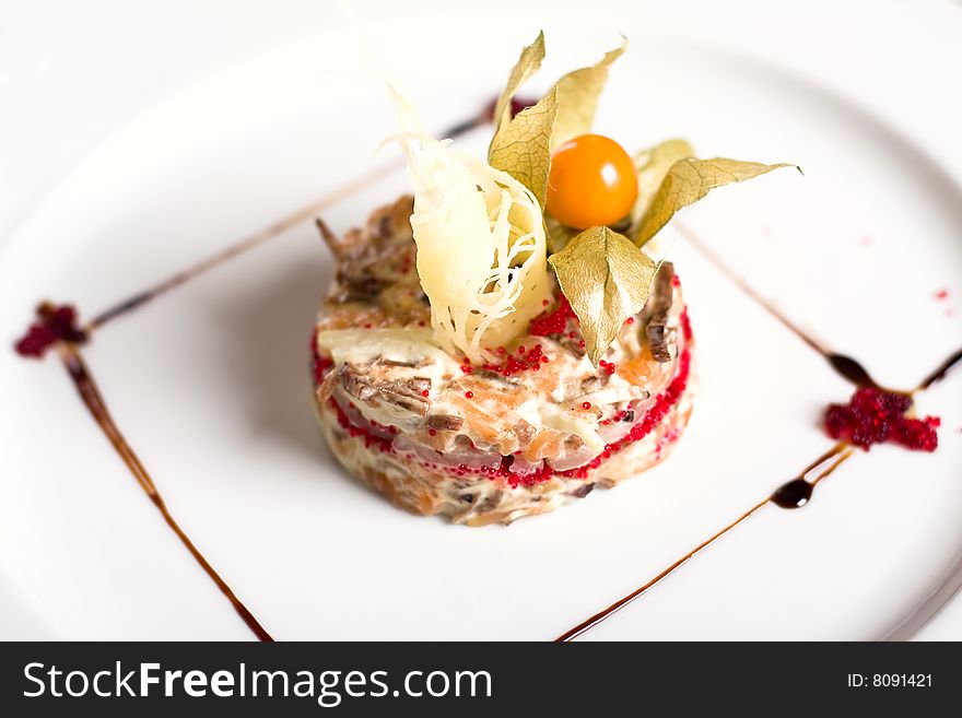 A fusion vegetables and meat salad on a plate (close-up). A fusion vegetables and meat salad on a plate (close-up)