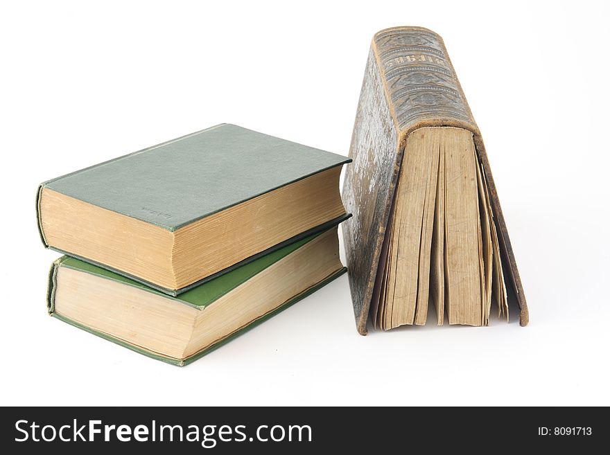 Three old books on a white background