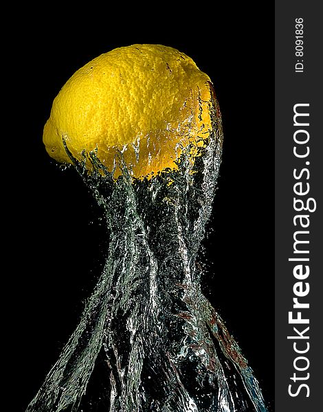 Lemon in water splashes on a black background