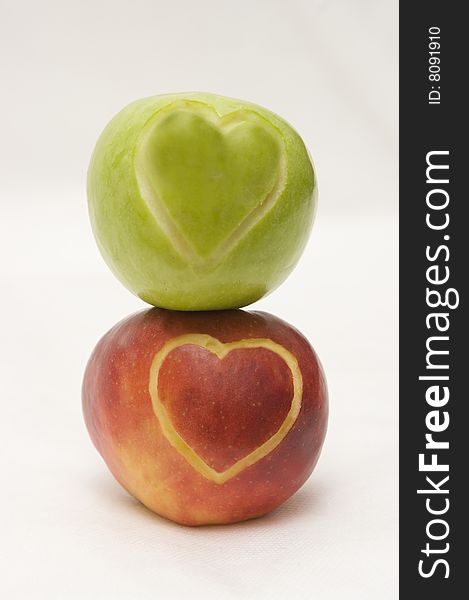 The image of two apples on which hearts are cut out. The image of two apples on which hearts are cut out