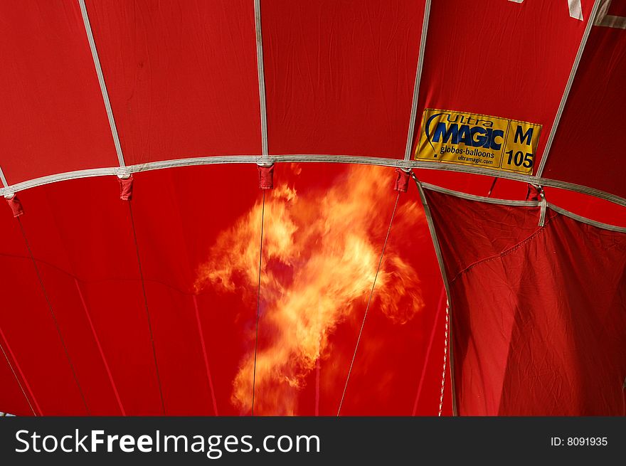 Cold air is filling a red balloon during the balloon meeting in Carpineti (Italy-Reggio Emilia). Cold air is filling a red balloon during the balloon meeting in Carpineti (Italy-Reggio Emilia).