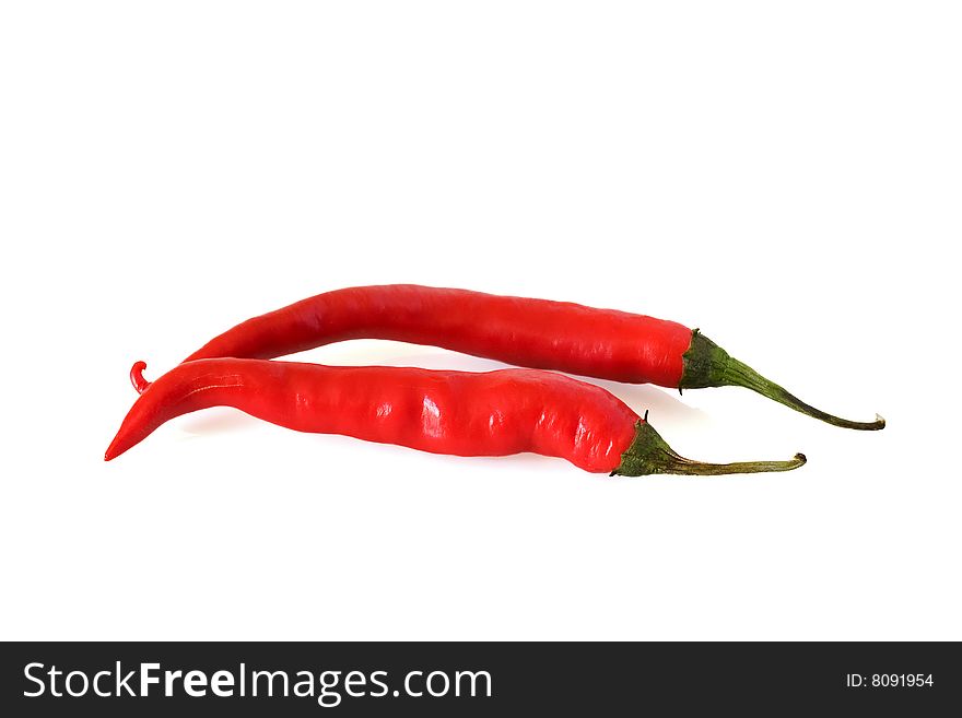 Two red hot chillis against a white background. Two red hot chillis against a white background