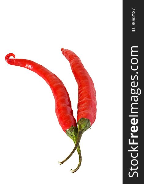 Two red hot chillis against a white background. Two red hot chillis against a white background