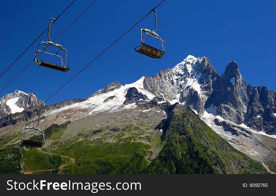 SavoskÃ© Alps in the foreground with a cable car. SavoskÃ© Alps in the foreground with a cable car