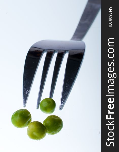 Green peas with fork background. Green peas with fork background