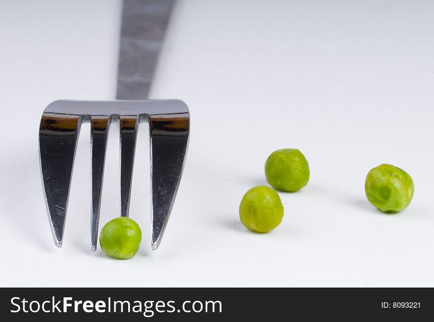 Green peas with fork background. Green peas with fork background