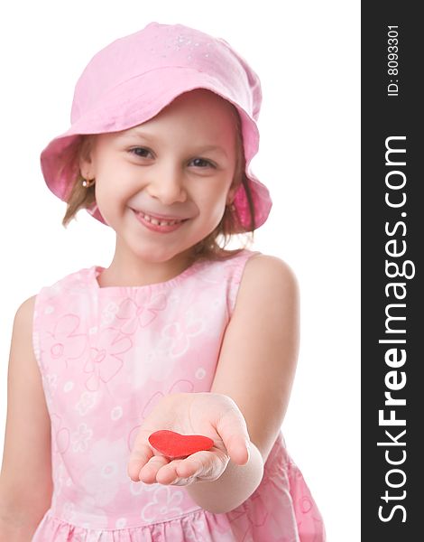 Girl holds a red heart in an outstretched arm. Girl holds a red heart in an outstretched arm