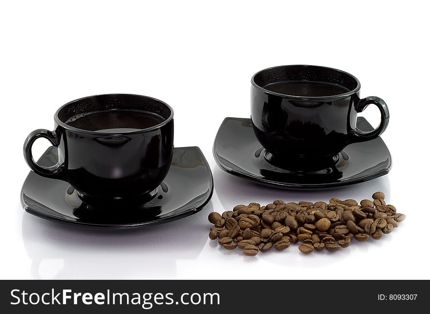 Two cups and coffee beens isolated on white background