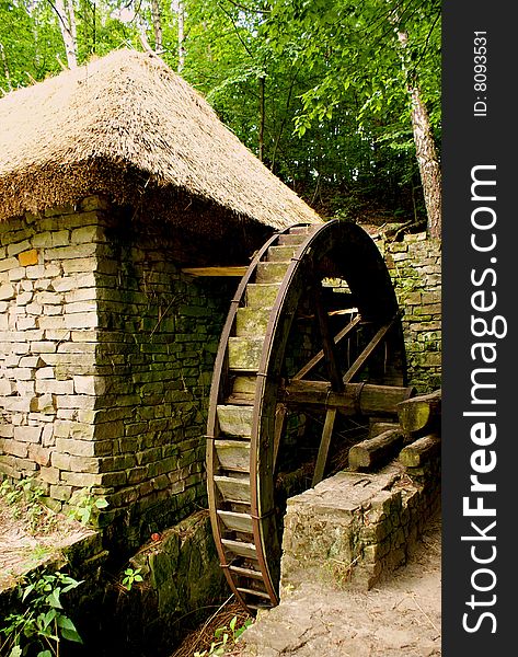 Old stone mill with wheel for making turns. Old stone mill with wheel for making turns
