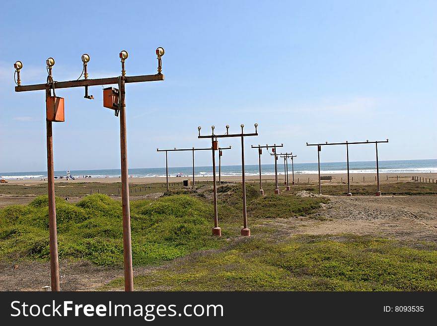 Runway lights on the beach help guide airplanes to the nearby airport. Runway lights on the beach help guide airplanes to the nearby airport