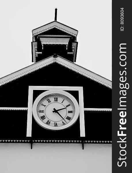 Old white and black chapel with tenon and clock. Old white and black chapel with tenon and clock
