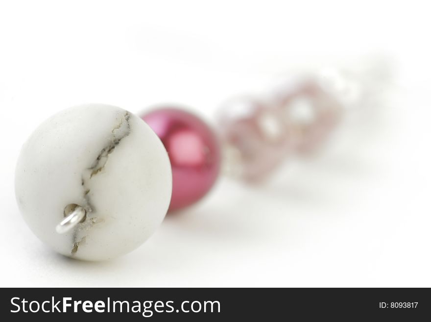 Fragment of Necklace with colored and Marble Beads on a white background. Soft focus view.