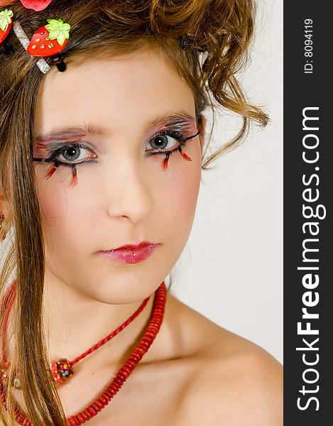 Closeup of young fashion girl with special eye makeup and red necklace. Closeup of young fashion girl with special eye makeup and red necklace