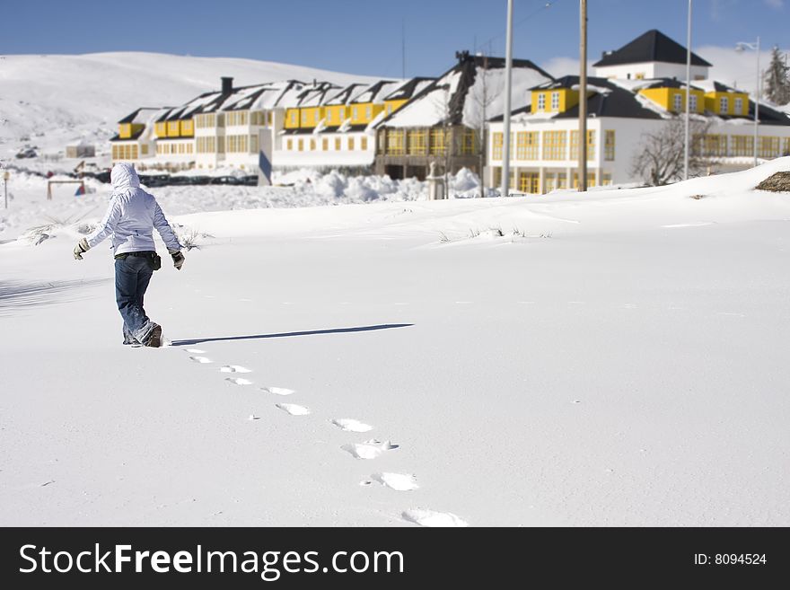 Young girl walk at a beautiful snow landscape