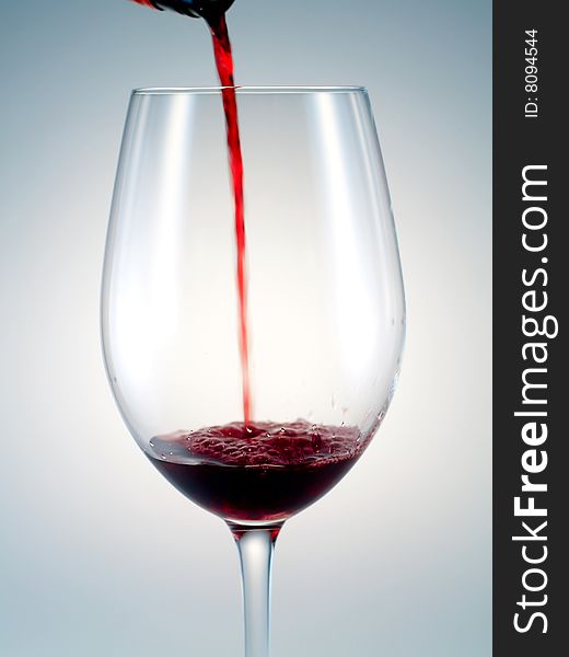 Pouring red wine into wineglass. Pouring red wine into wineglass