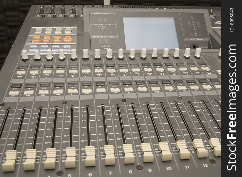 A close up of a sound and music mixer in the studio.