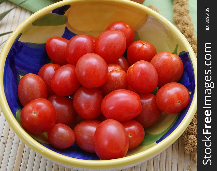 Some little tomatoes in a beautiful, bowl