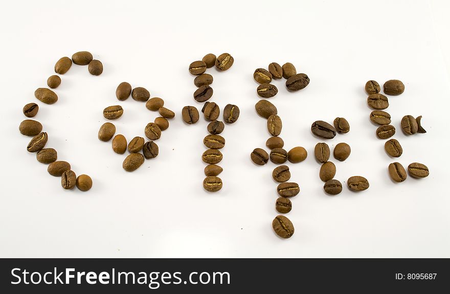 Word from coffee grains on a white background