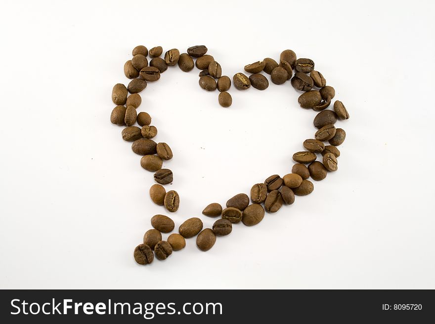 Heart from coffee grains on a white background
