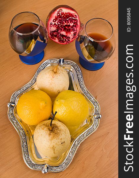 Two glasses with wine and fruit on a silver tray. Two glasses with wine and fruit on a silver tray.