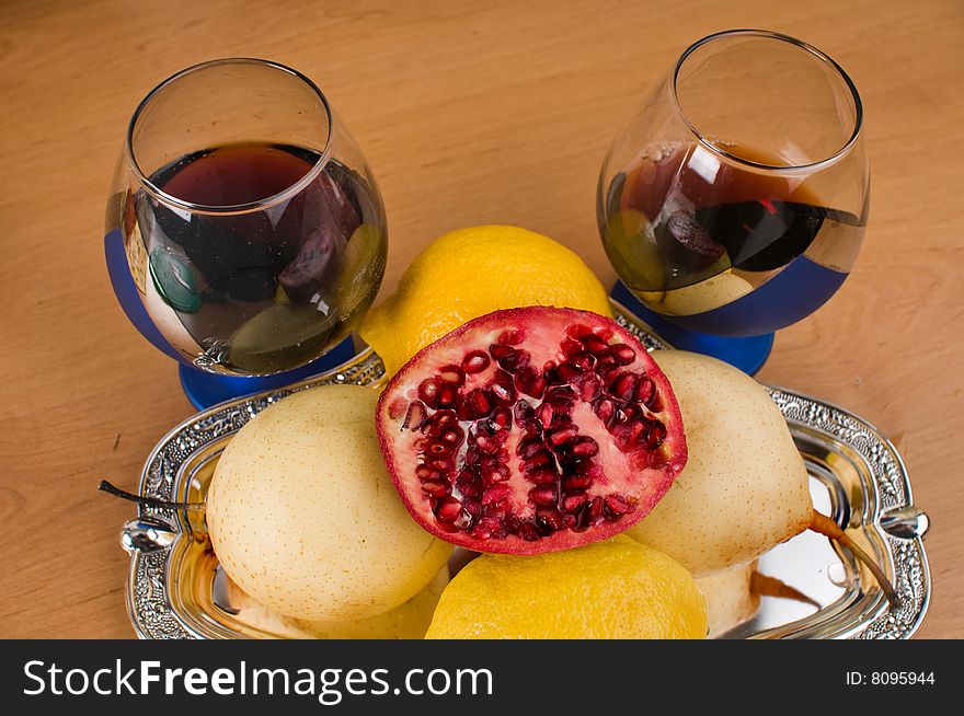 Two glasses with wine and fruit on a silver tray. Two glasses with wine and fruit on a silver tray.