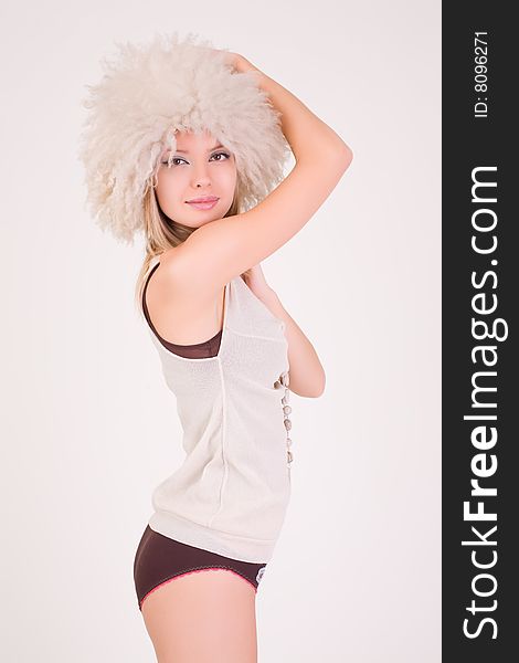 Romantic girl in furry hat, studio shot