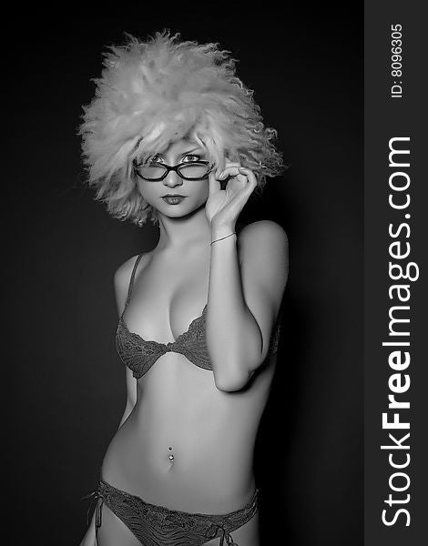 Attractive girl in glasses and furry hat, grayscale