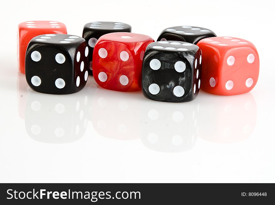 Four black and three red dices with numbers six and number one. Four black and three red dices with numbers six and number one