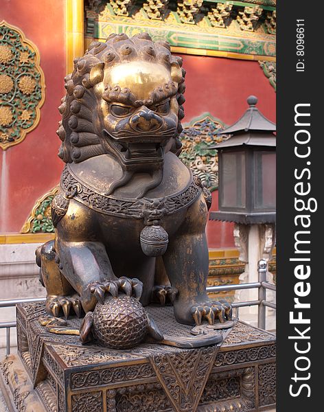 Religious metal lion sitting in the forbidden city