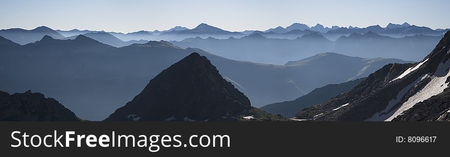 Panoramic view of misty mountain range in the Caucasian mountains. Panoramic view of misty mountain range in the Caucasian mountains