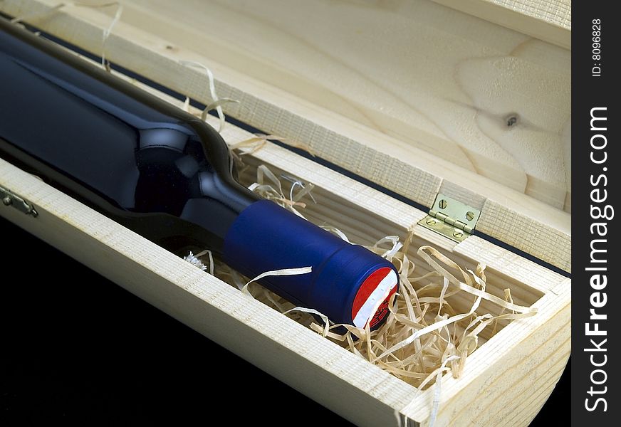 A Bottle Of Red Wine In A Crate