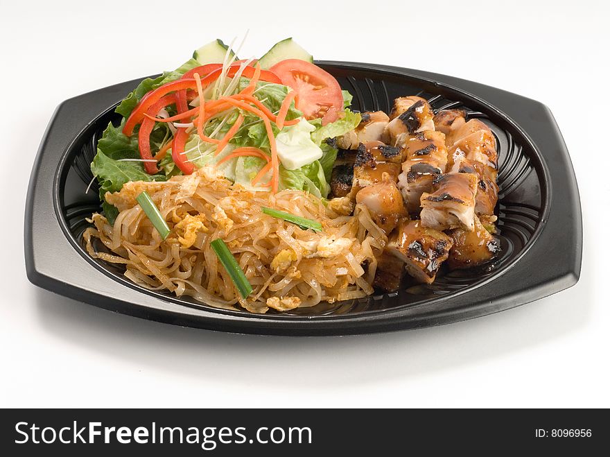 Glazed barbecue chicken with noodles and a salad