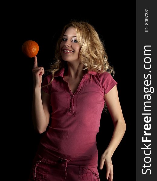 Beautiful teen lady in spinning orange on finger. Beautiful teen lady in spinning orange on finger