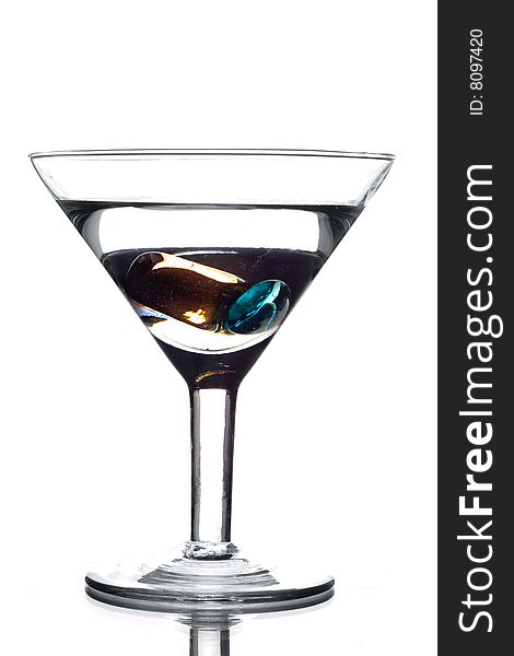 Martini glass with water and colored crystals inside