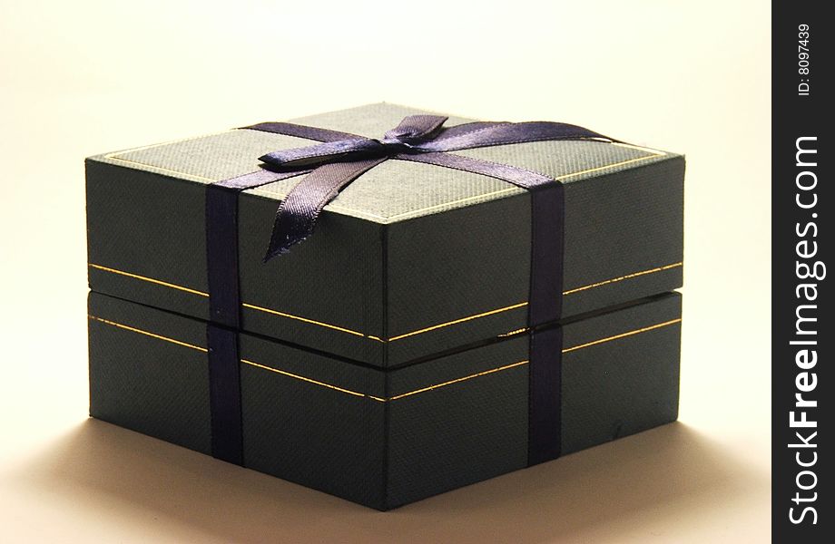 Green gift box with blue ribbon