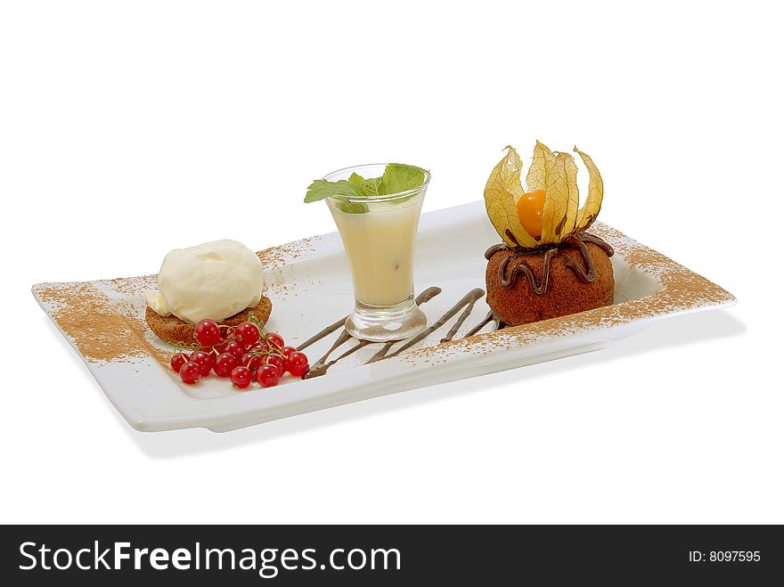 Chocolate cake on a decorated plate with vanilla ice cream, sauce and red currant. Isolated. Chocolate cake on a decorated plate with vanilla ice cream, sauce and red currant. Isolated.