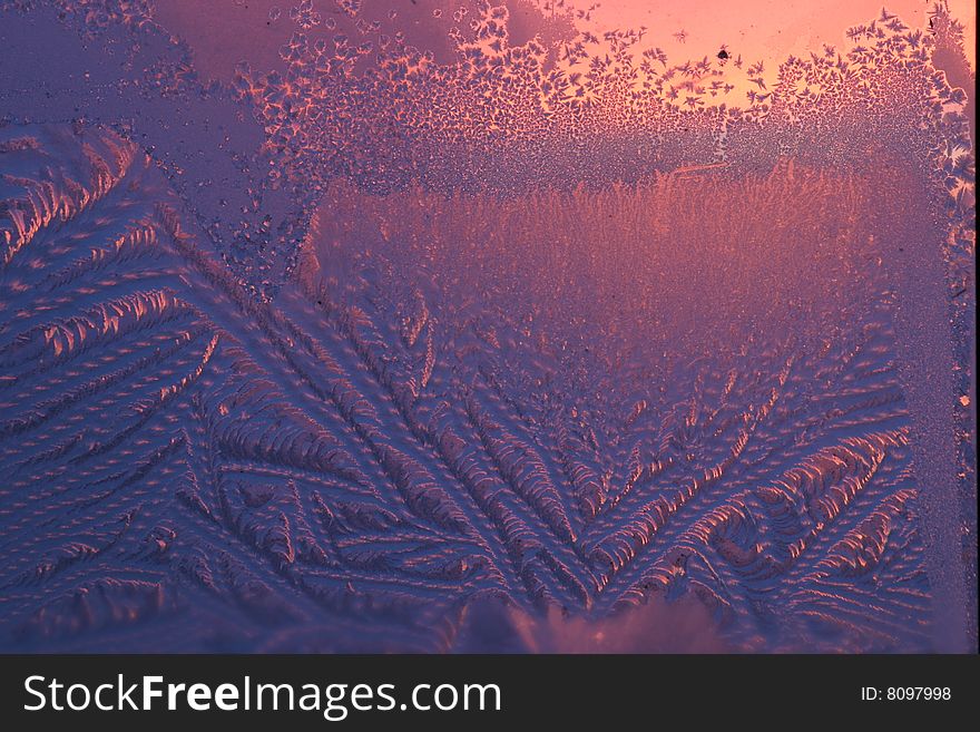 Winter evening sunset. Hoarfrost on a window-pane. Winter evening sunset. Hoarfrost on a window-pane.