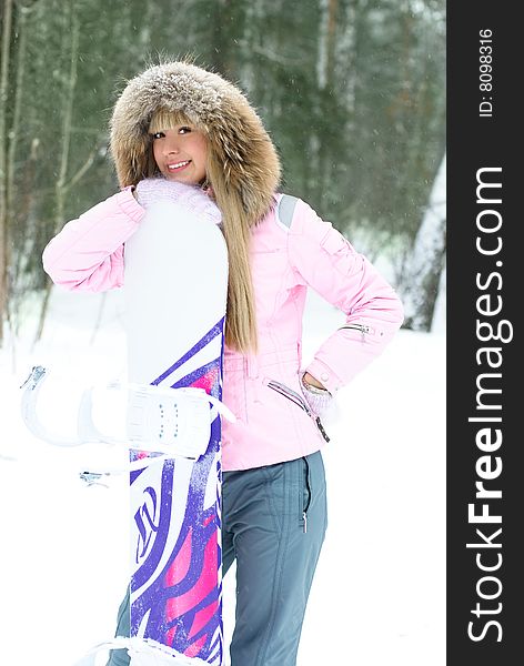 Portrait of a beautiful young blond woman with a snowboard outdoor. Portrait of a beautiful young blond woman with a snowboard outdoor