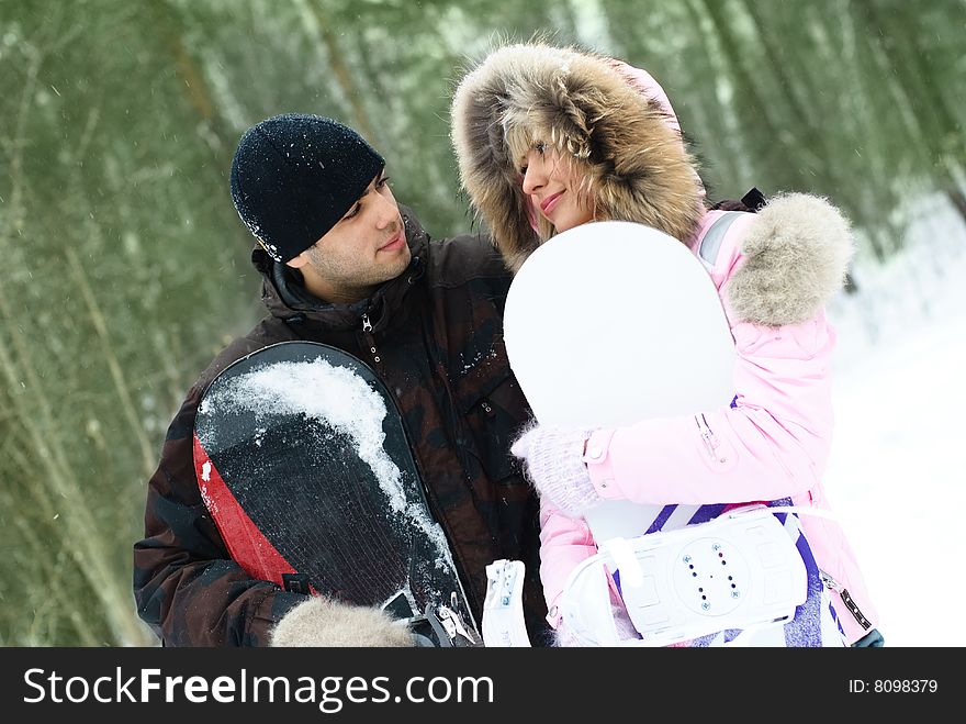 Young couple with snowboards