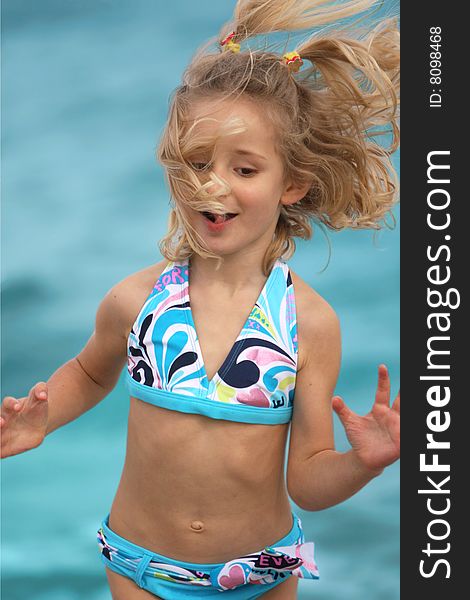 Little girl jumping on the beach