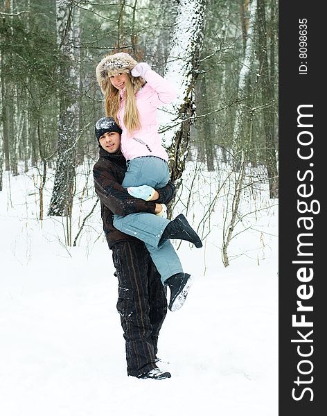 Portrait of a beautiful young couple having fun in winter park. Portrait of a beautiful young couple having fun in winter park