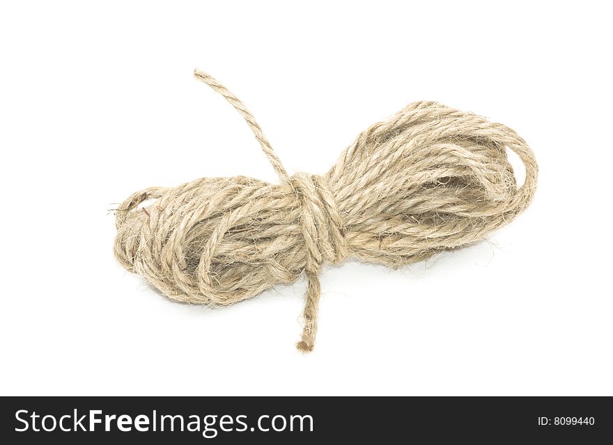 Small bundle of coarse brown string on white background