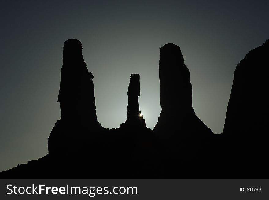 Sun Setting behind Buttes at Monument Valley. Sun Setting behind Buttes at Monument Valley