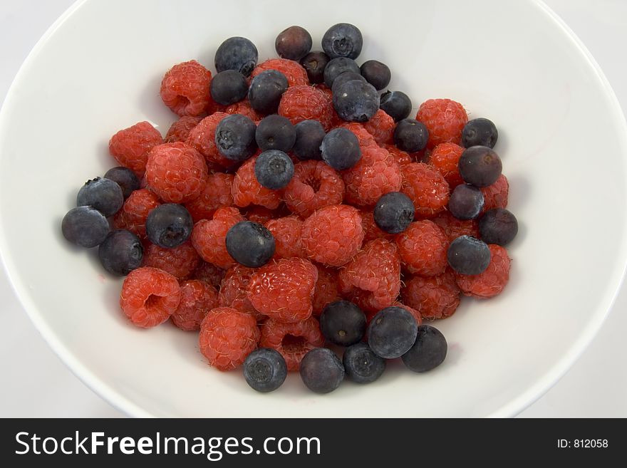 Delicious Blueberry And Raspberry Desset In Plain White Bowl.