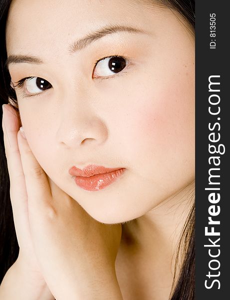 A beautiful young asian woman resting head on hands. A beautiful young asian woman resting head on hands