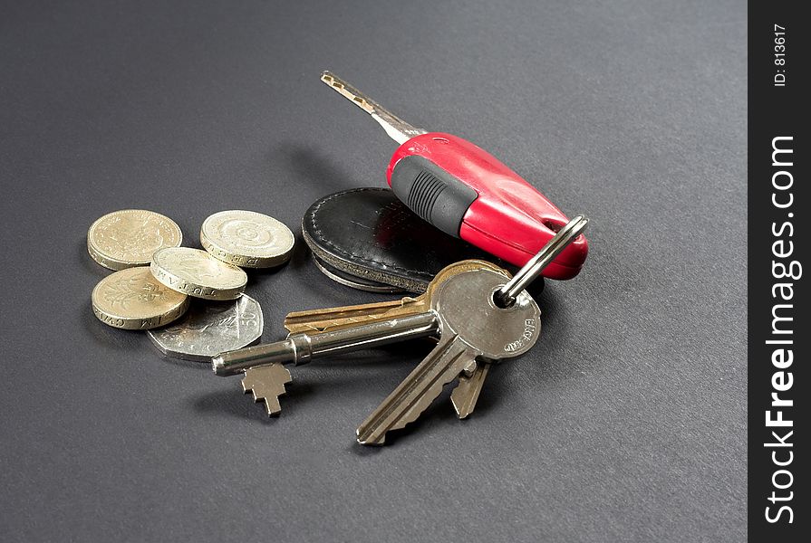 Car and house keys and coins