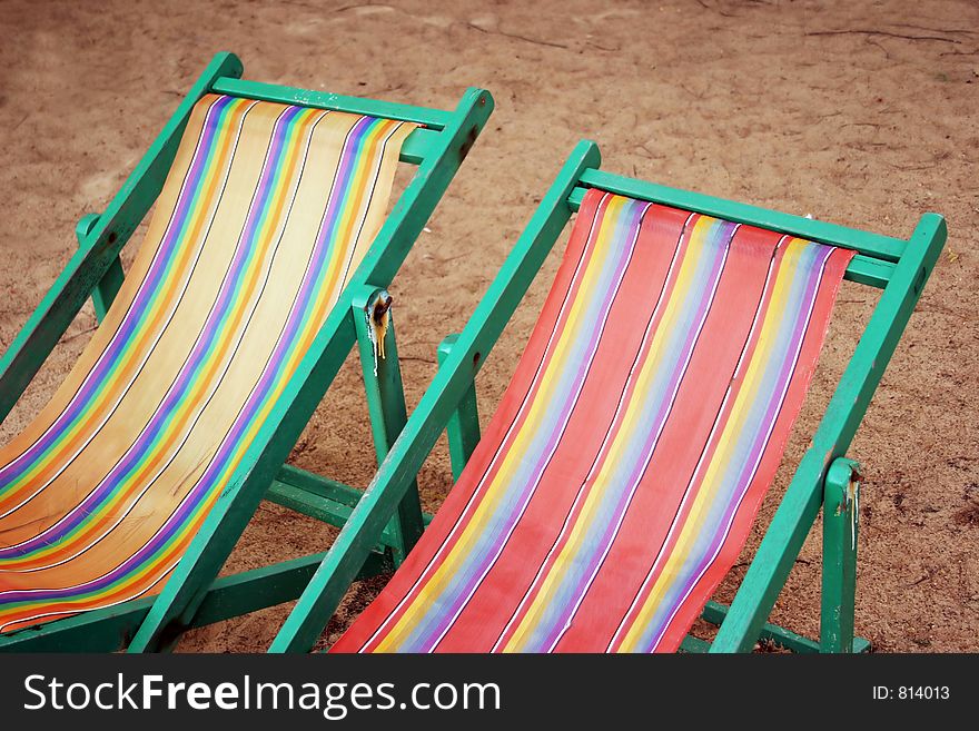 Striped and colorful - old faded deck chairs. Striped and colorful - old faded deck chairs