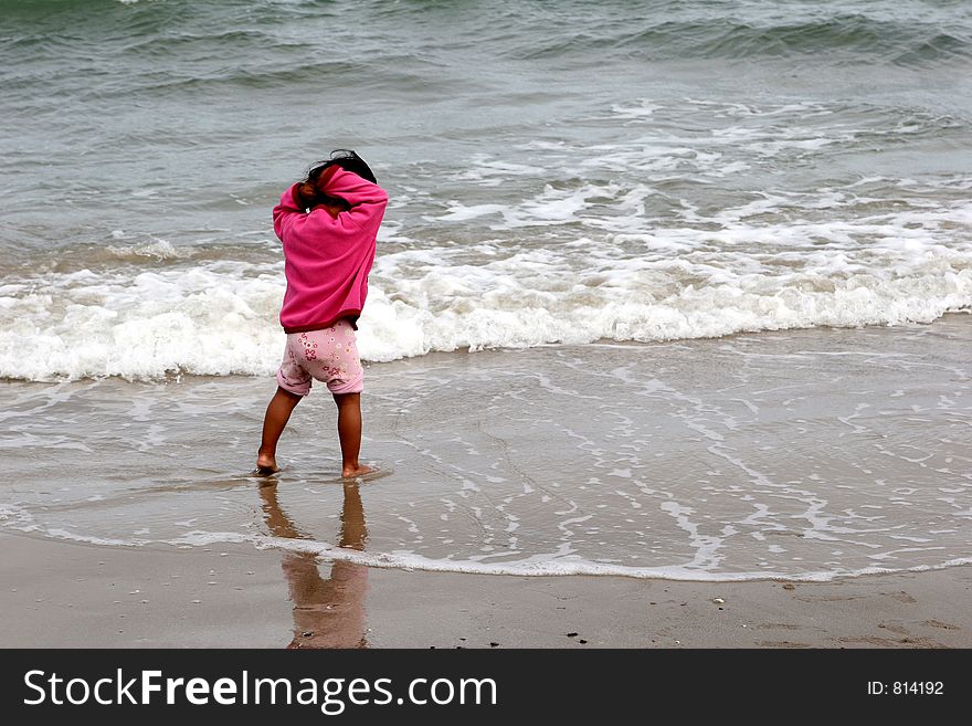 Summer in denmark:a child on the beach hands up