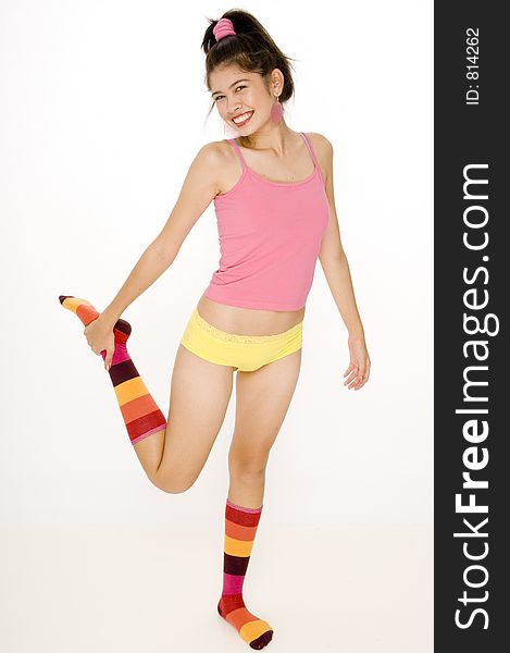 A full-length photo of a teenage woman in colorful socks and clothing. A full-length photo of a teenage woman in colorful socks and clothing